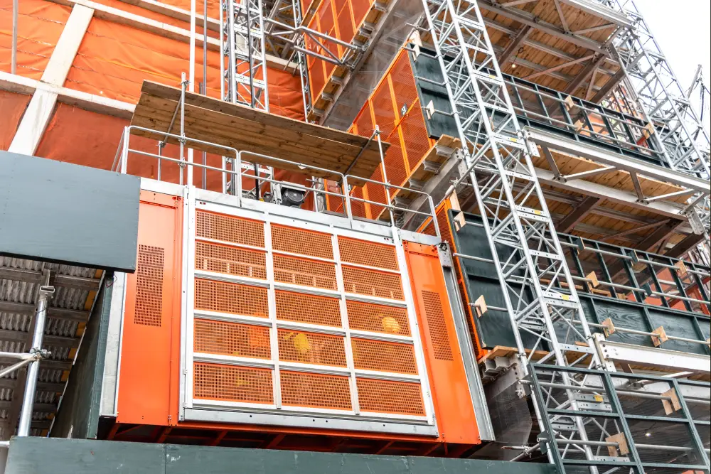 Outdoor steel frame structure being attached to an existing house for elevator retrofitting.