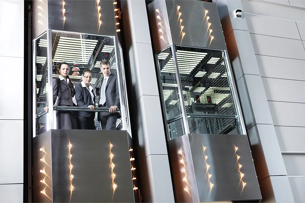 Glass panoramic elevator shaft in modern building